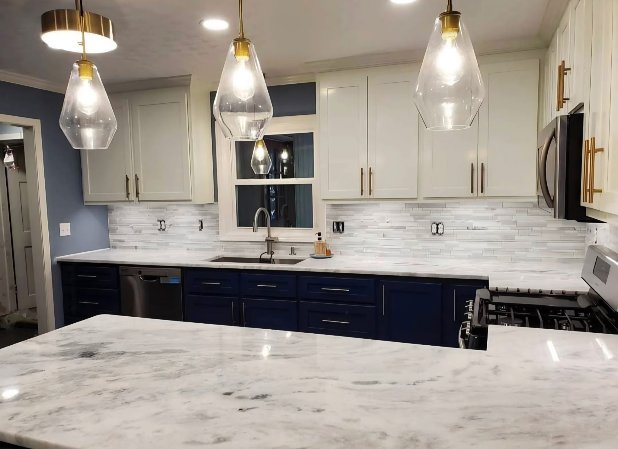 Navy and white kitchen with quartzite countertops